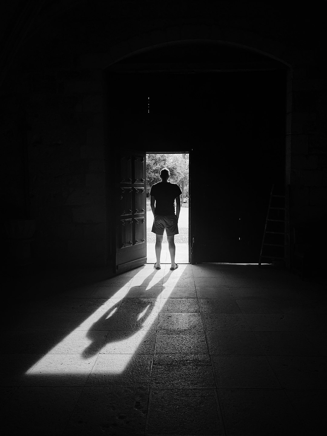 man standing beside door