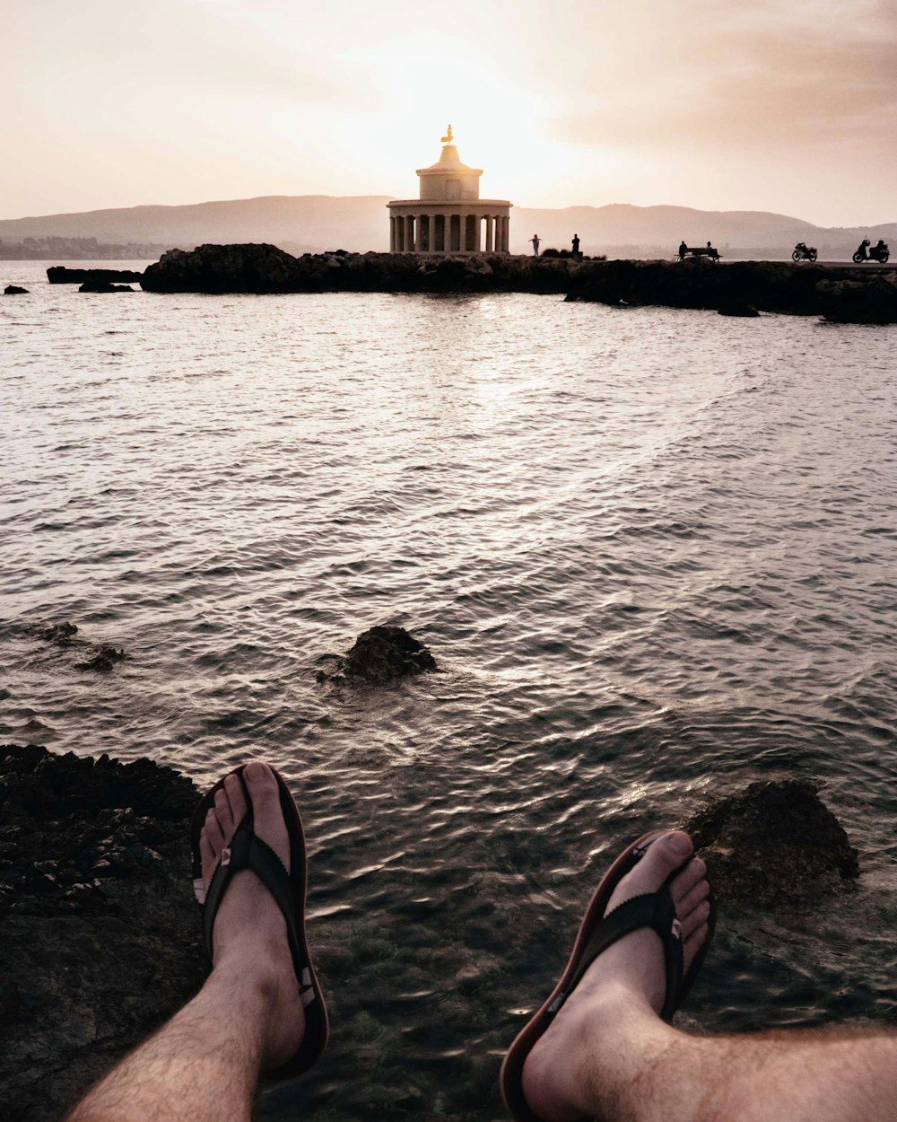 person wearing black flip-flop close-up photography