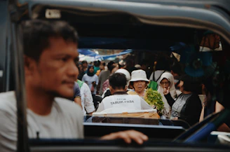 A bustling city street scene capturing everyday life and diverse people interacting.