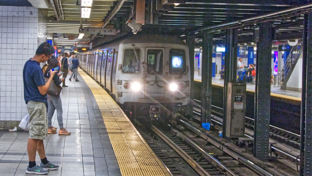 people standing in subway station