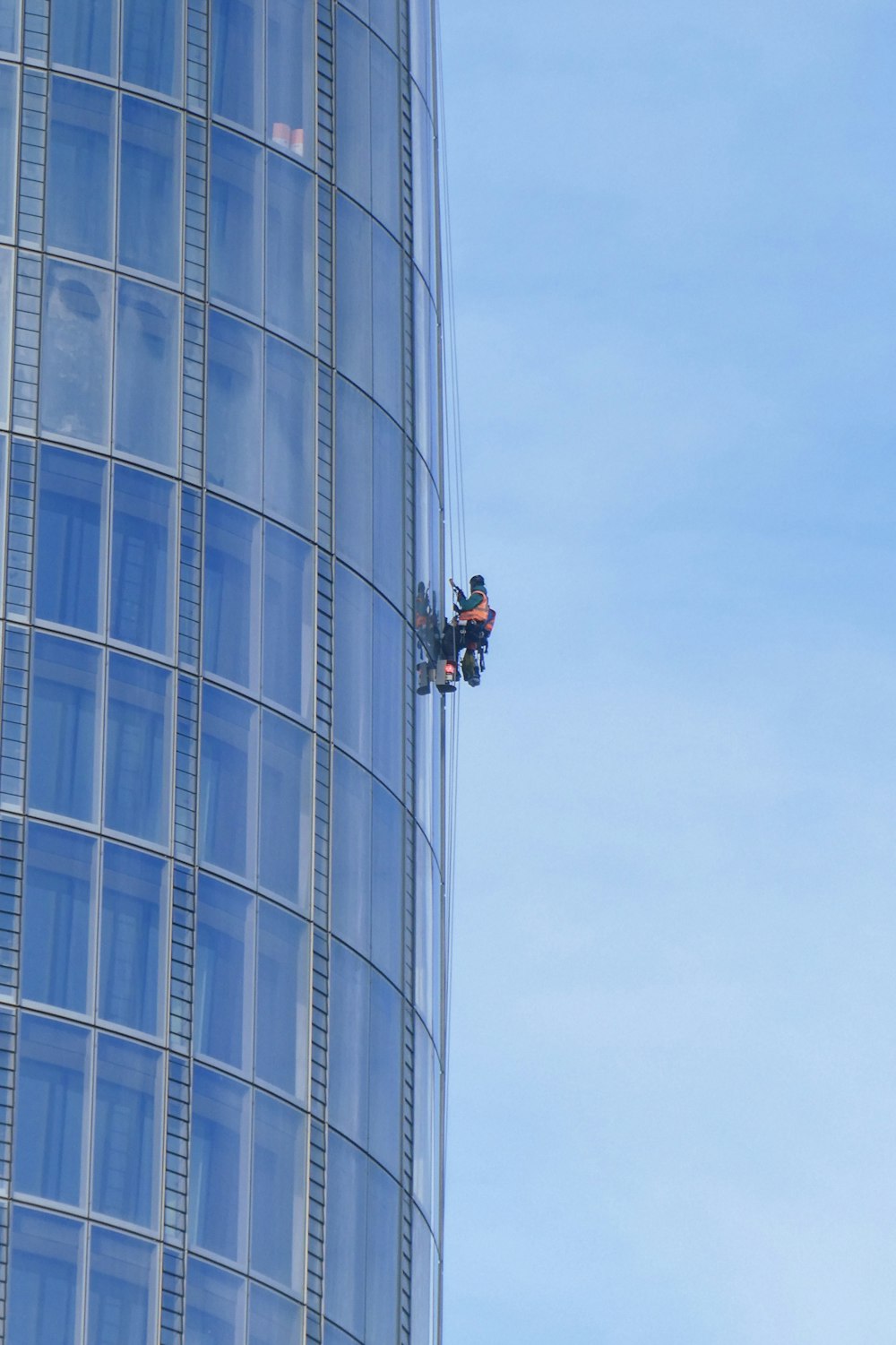 person cleaning building windows