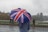 person holding blue, white, and red umbrella