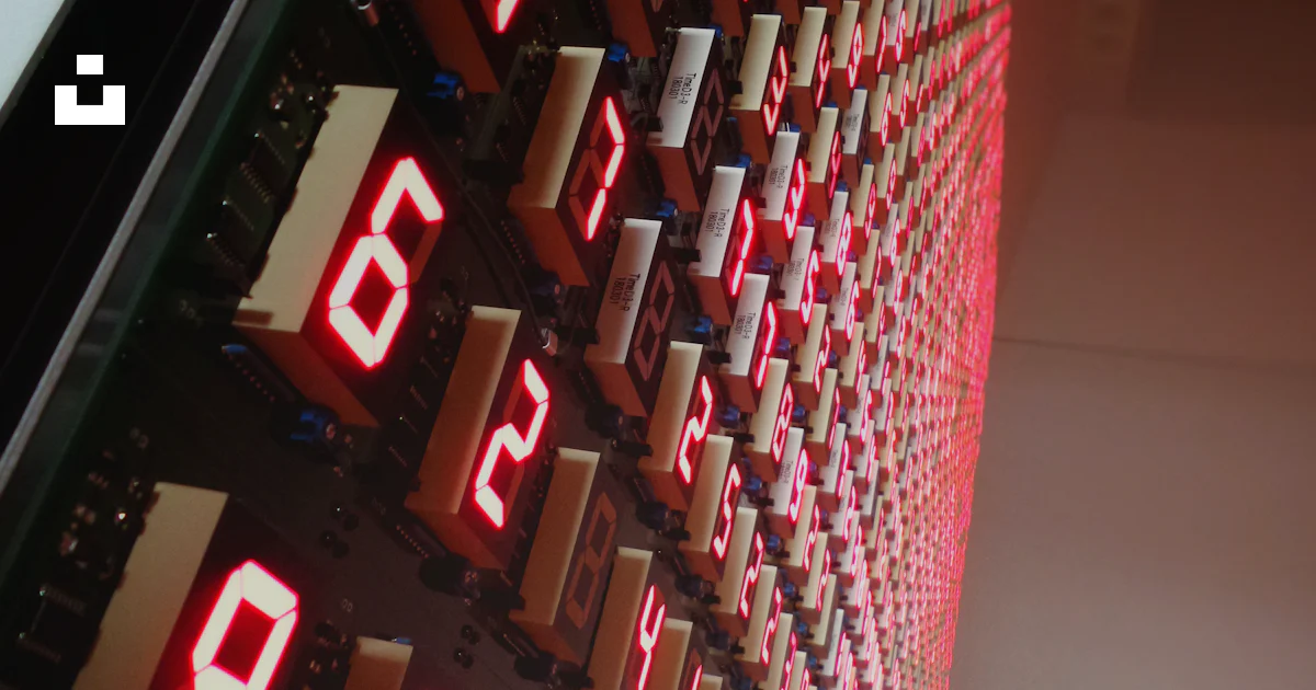 Red Numbers Code Wall A large display of red numbers on a wall photo – Free Building Image on ...