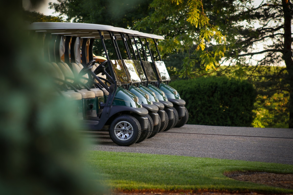 Golf carts on a course pathway, showcasing powered golf transport options