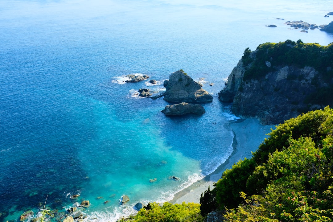 rock formation in a body of water during daytime