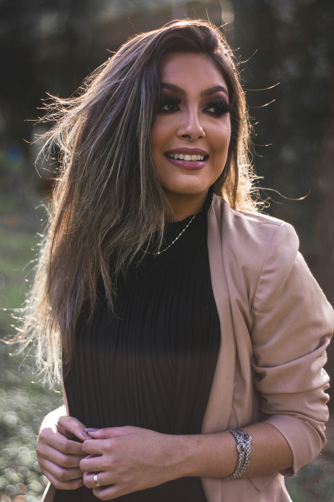 woman smiling wearing brown jacket