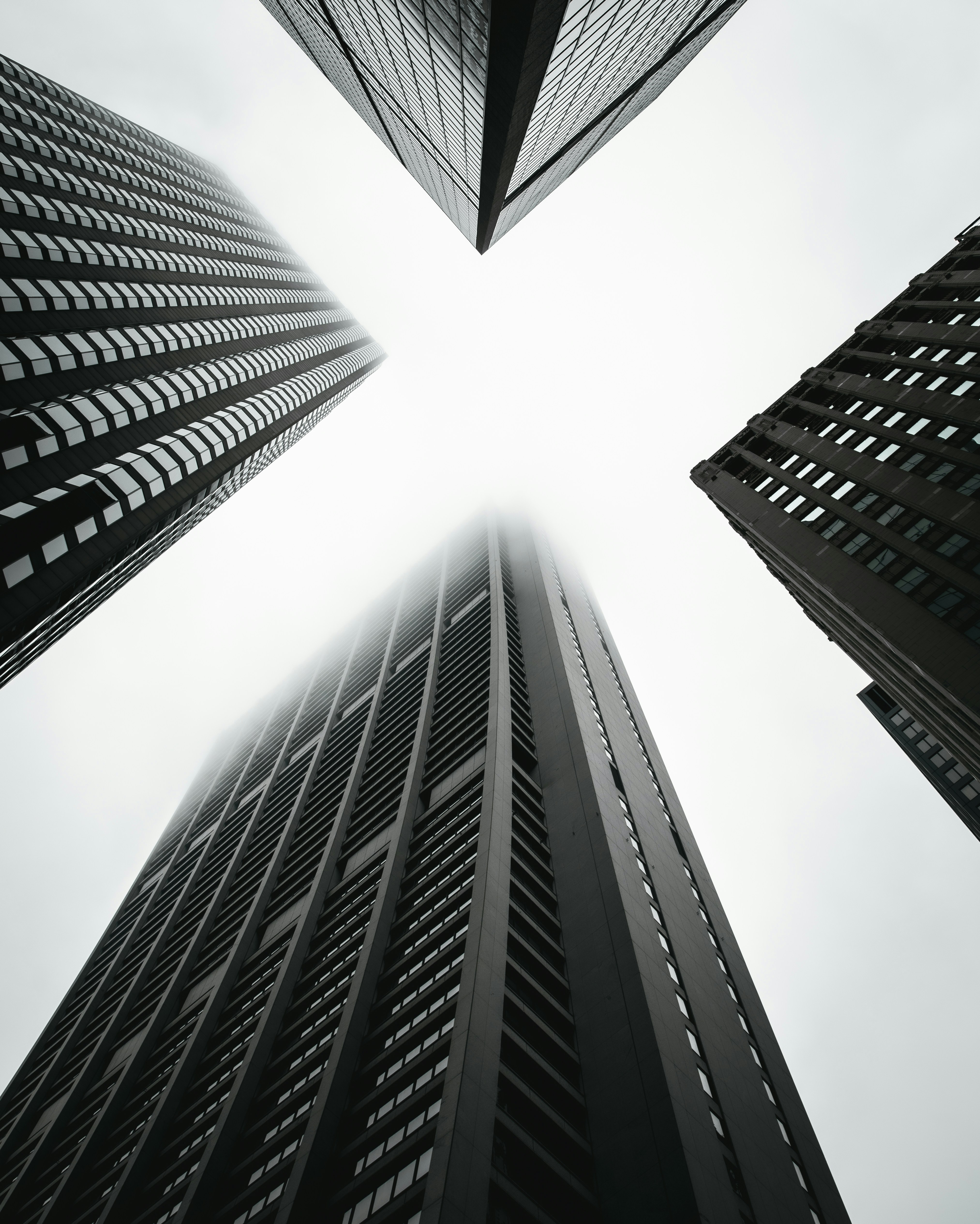 low angle photography of four high-rise buildings