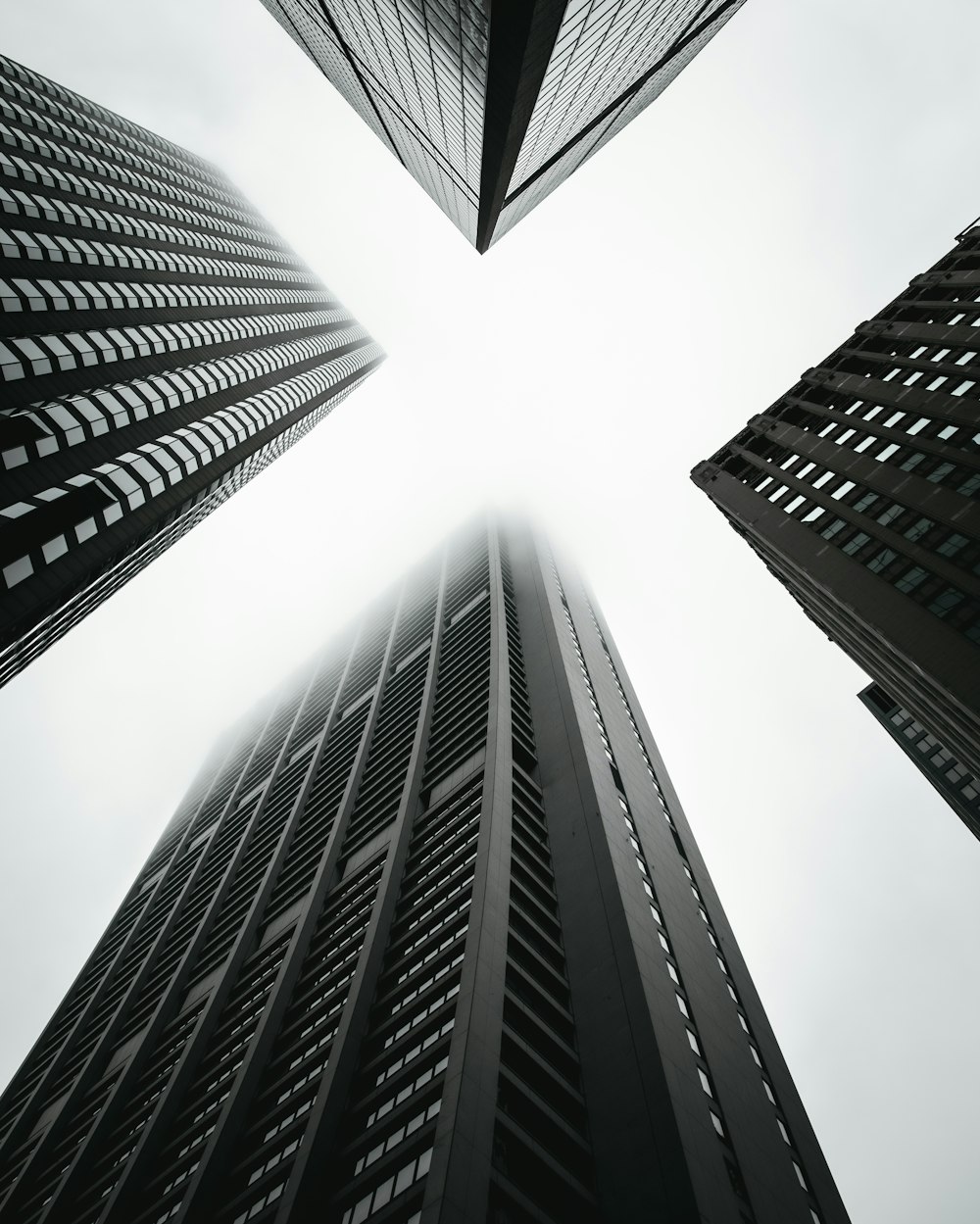 low angle photography of four high-rise buildings