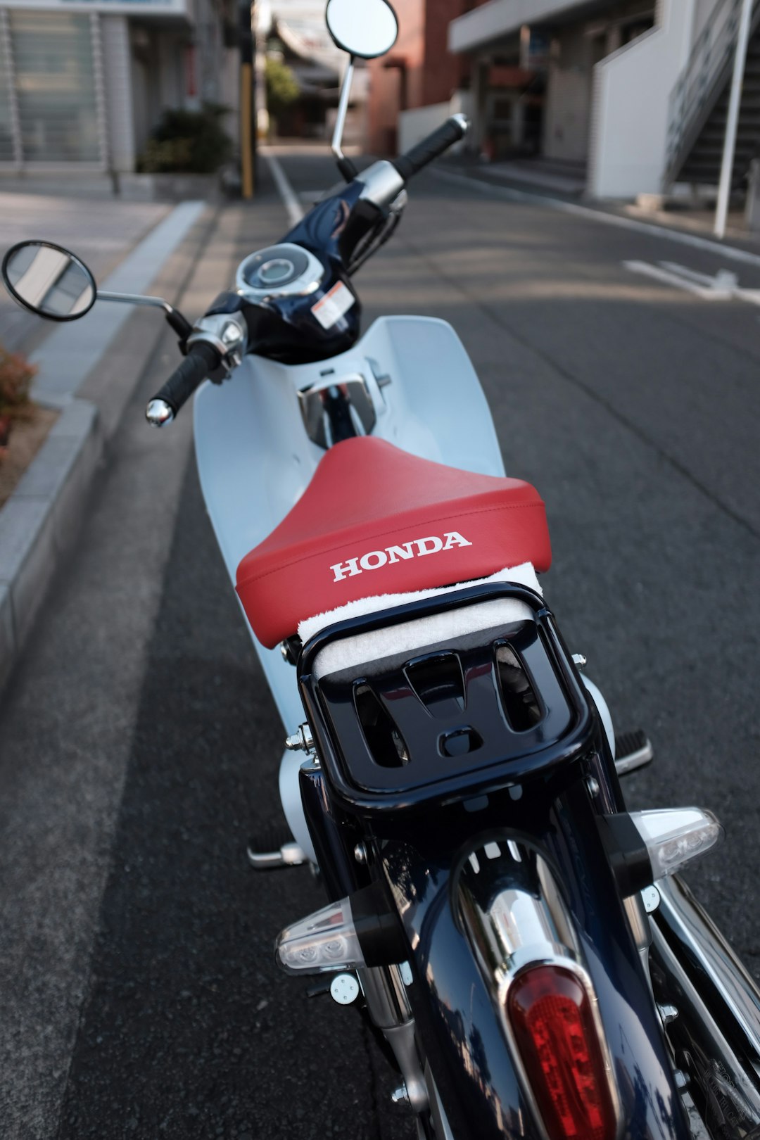 white and red Honda motorcycle
