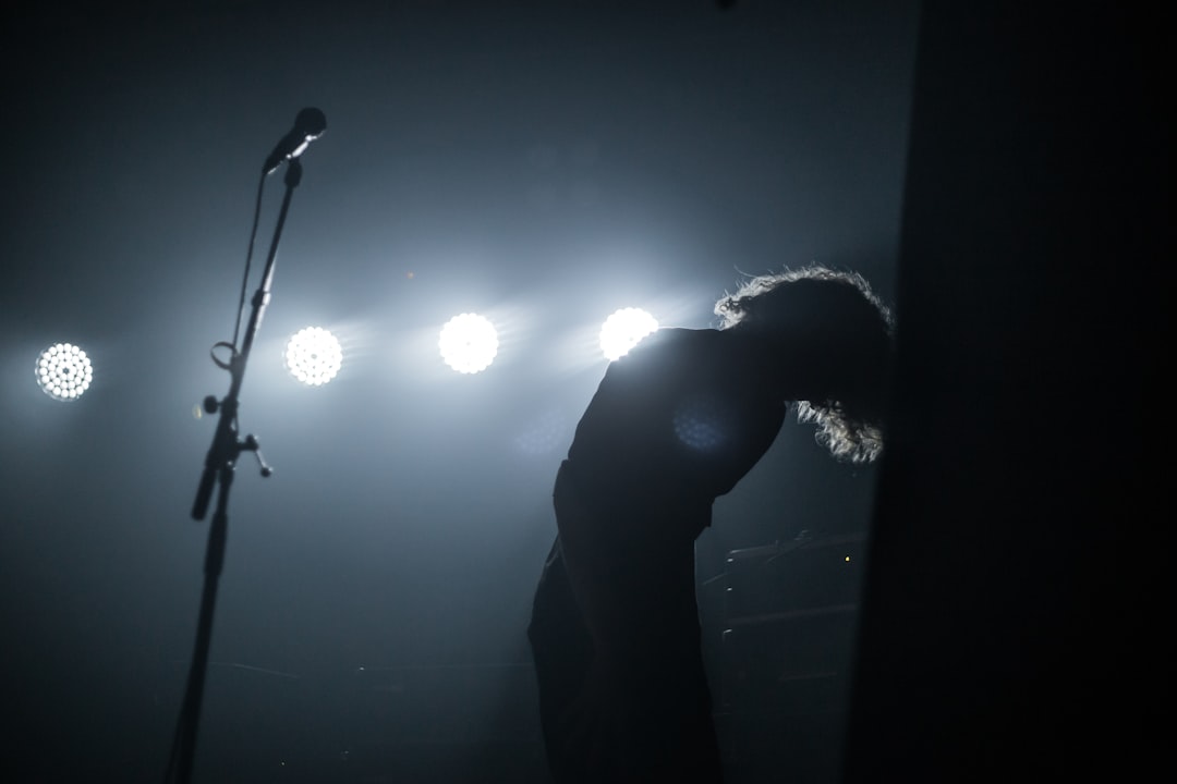 person standing beside microphone stand