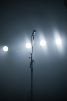 A microphone on a stage with soft lighting in the background