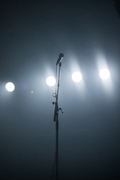 A lively stage with a microphone and spotlight.