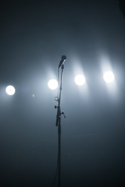 A vibrant stage with a microphone and spotlight, ready for a performance.