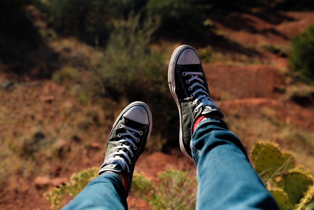 person wearing black-and-white low-top sneakers outdoor during daytime