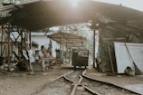 Researchers interviewing community members under a makeshift shelter.
