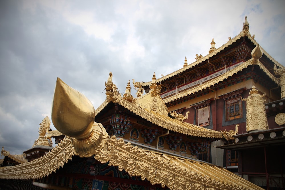 gold pagoda temple under cloudy sky during daytime