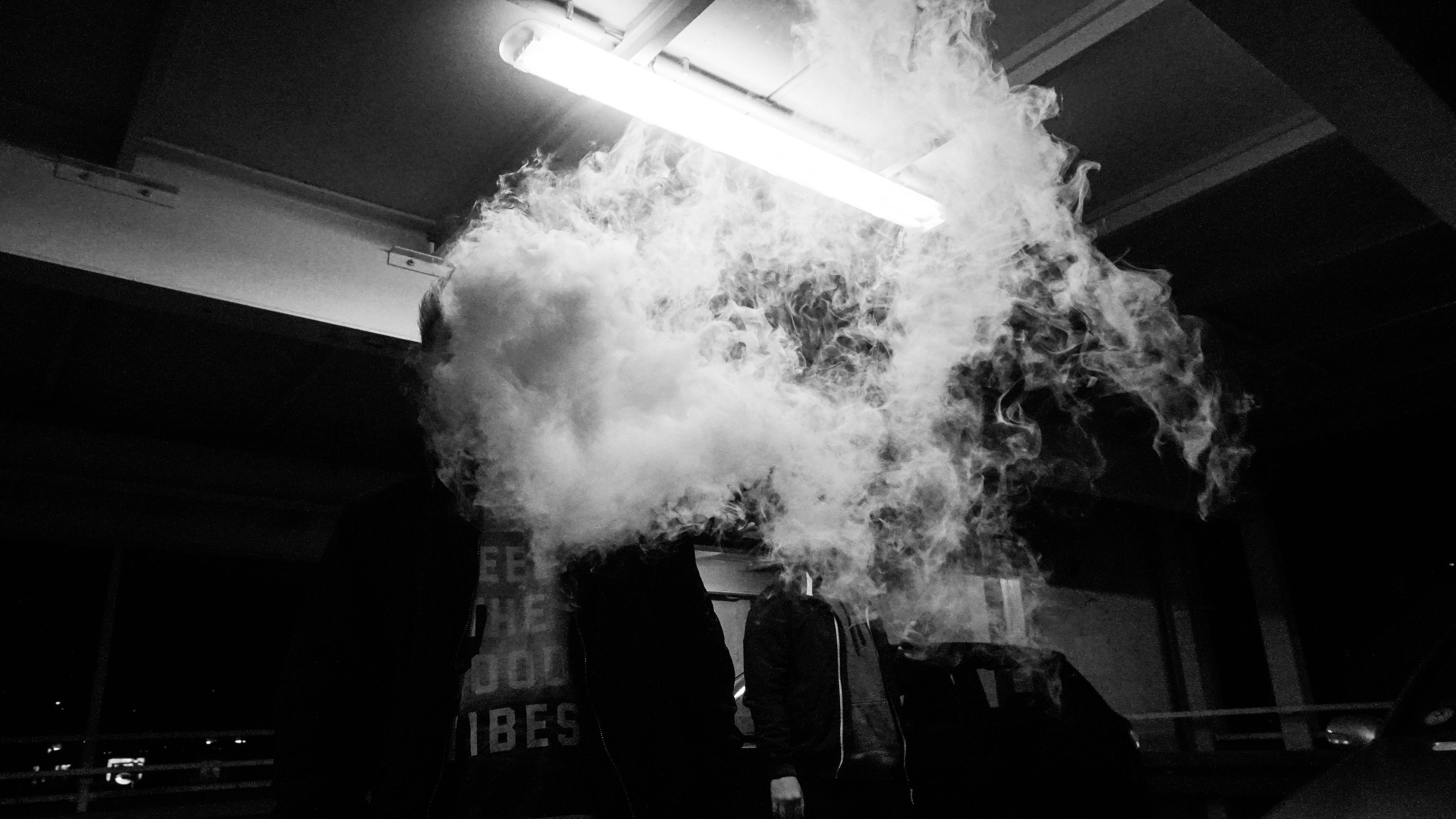 a black and white photo of smoke coming out of a suit case