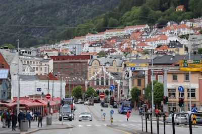 A bustling European city street filled with colorful buildings and happy travelers