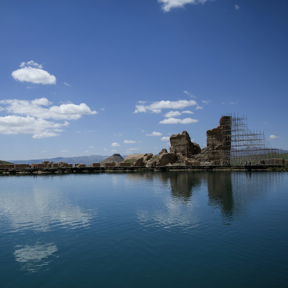 body of water across rocks during daytime