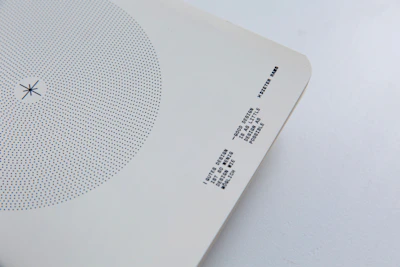 Circular photo of golden event tickets with a minimalist white background