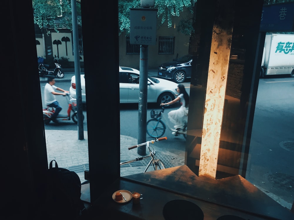 woman biking near store