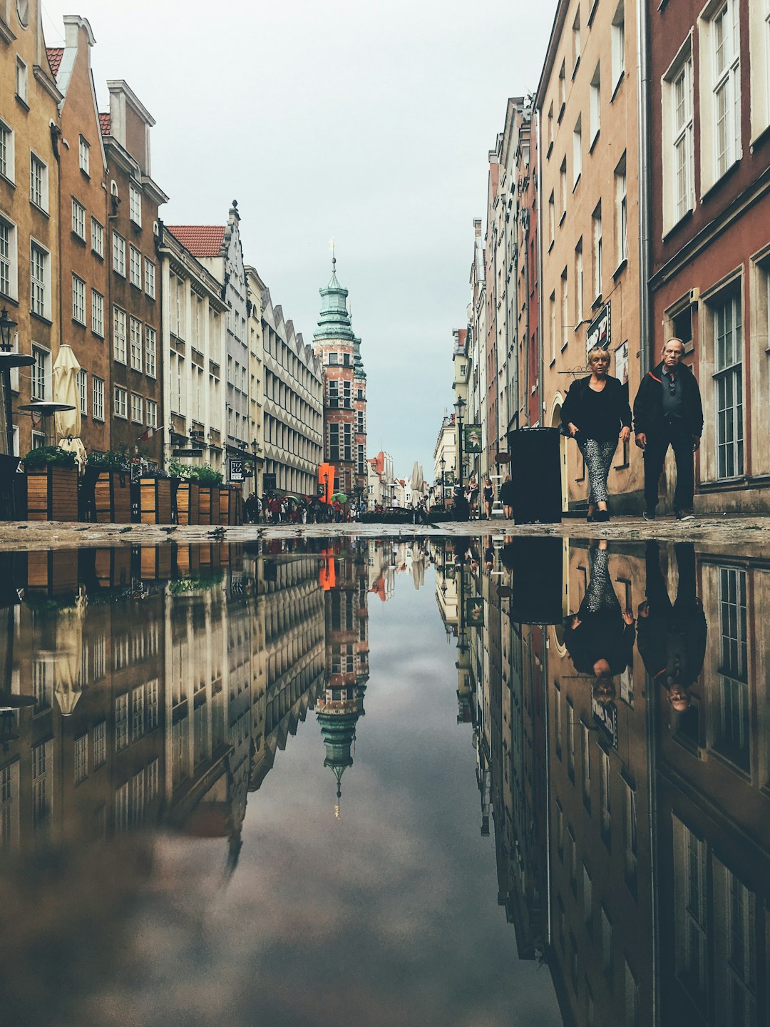 two person walking beside road