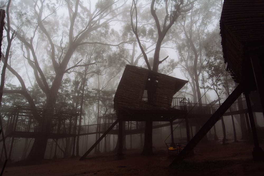 a tree house in the middle of a foggy forest