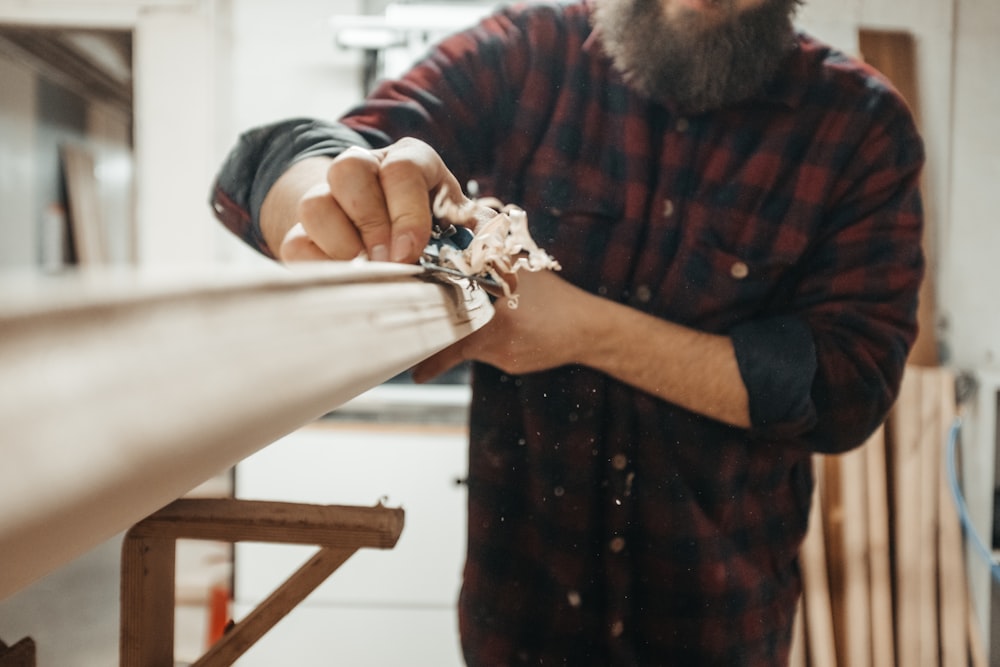 uomo che tiene la barra di legno