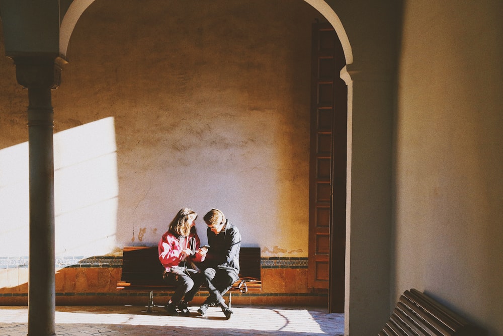 couple seated near wal