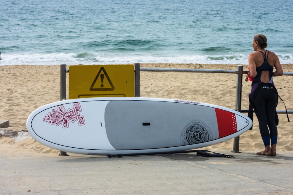 woman standing near surfboard