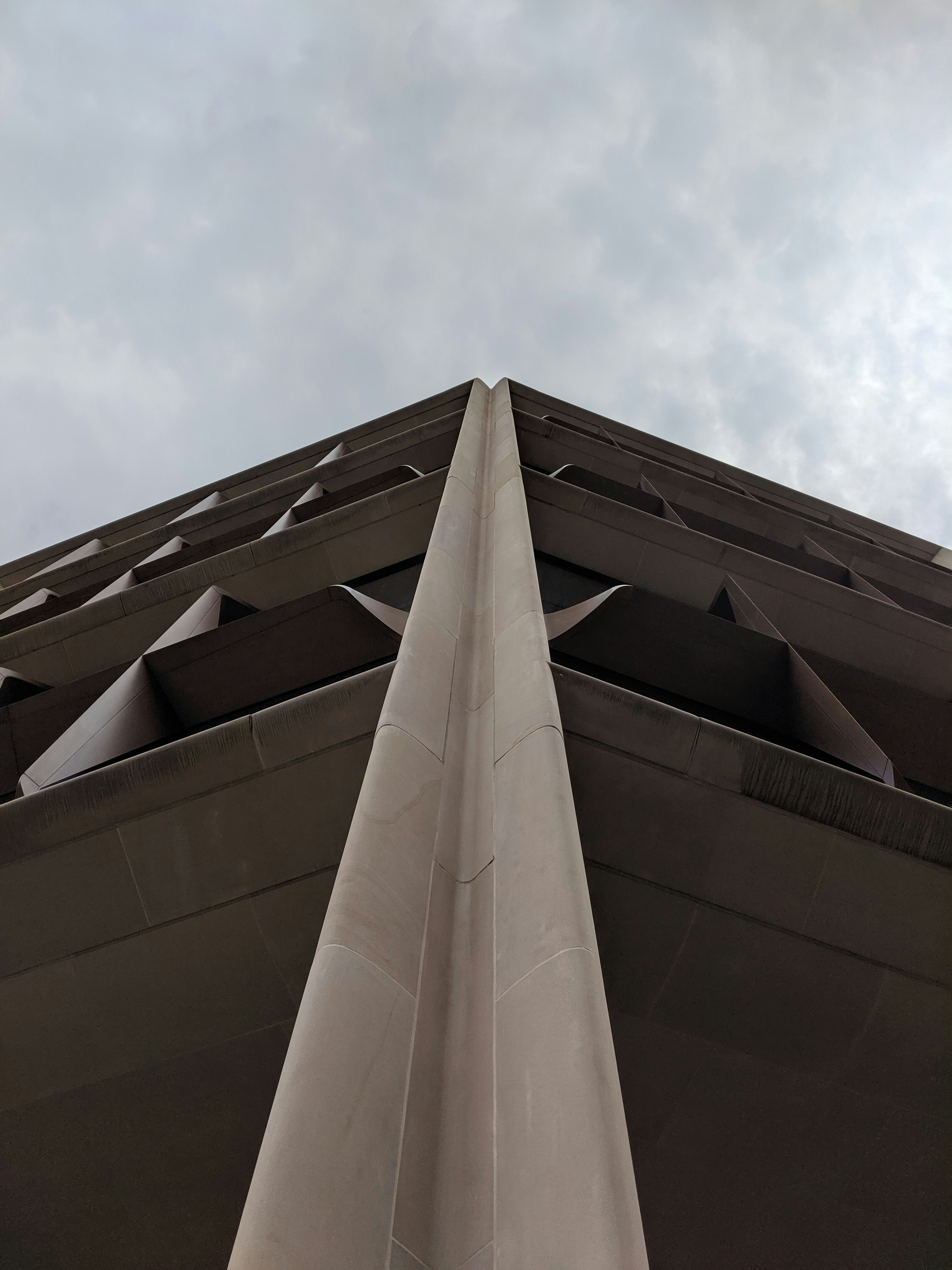 gray concrete building low-angle photography