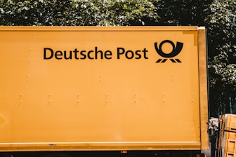 Australia Post delivery van driving through a suburban neighborhood.