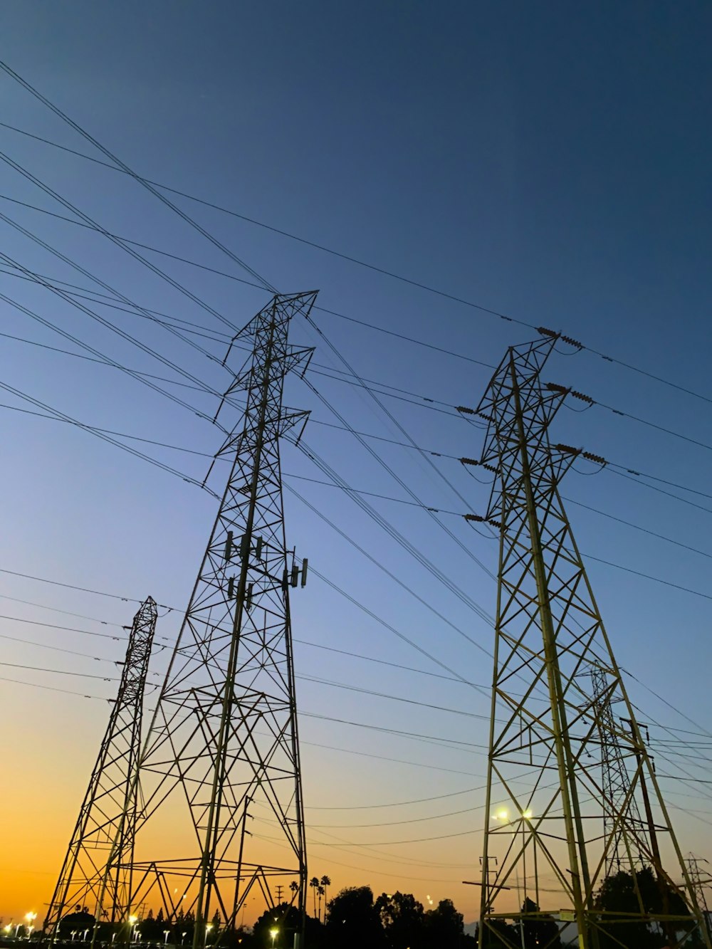 low-angle photography of utility towers