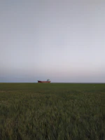 A serene planet surface with a lone explorer’s ship parked under twin suns.