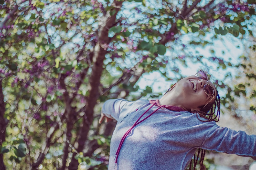 smiling woman wearing grey pullover hoodie