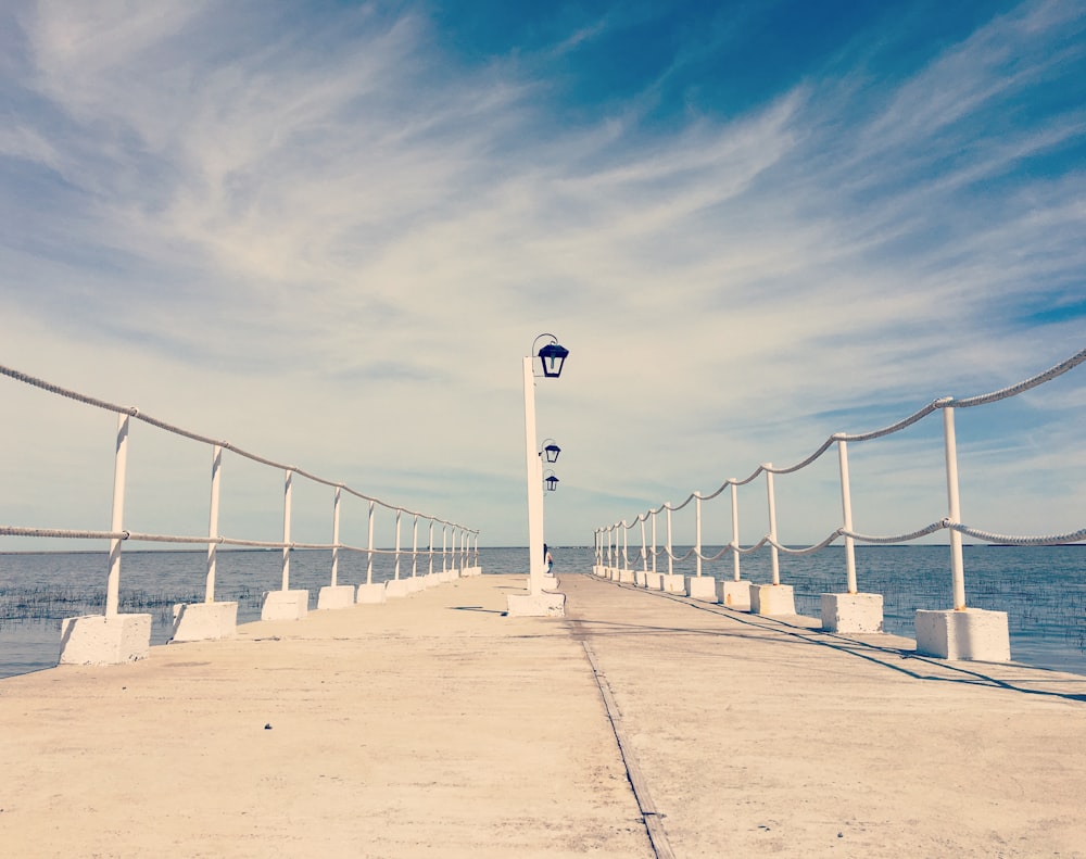 white lamp post near ocean during daytime