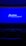 A dimly lit movie theater featuring rows of empty seats silhouetted against a large blue screen displaying the logo and website of the Institute of Cinema and Audiovisual Arts (INCAA) in Argentina.