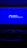 A dimly lit movie theater featuring rows of empty seats silhouetted against a large blue screen displaying the logo and website of the Institute of Cinema and Audiovisual Arts (INCAA) in Argentina.