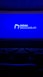 A dimly lit movie theater featuring rows of empty seats silhouetted against a large blue screen displaying the logo and website of the Institute of Cinema and Audiovisual Arts (INCAA) in Argentina.