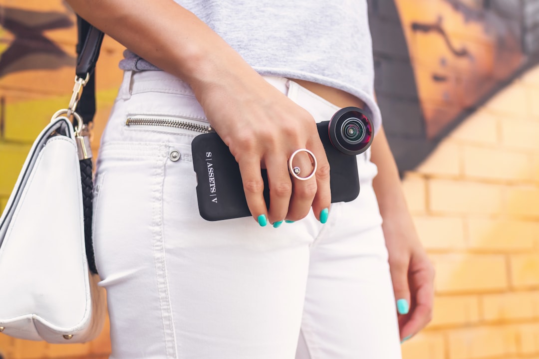 woman holding phone with clip lens