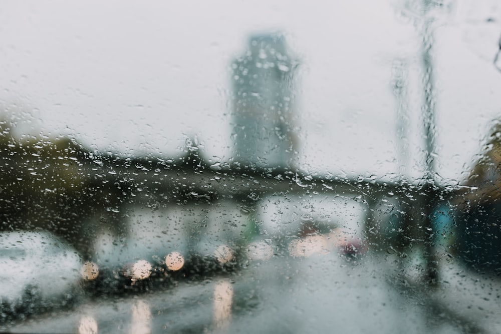 a view of a street through a rain covered window