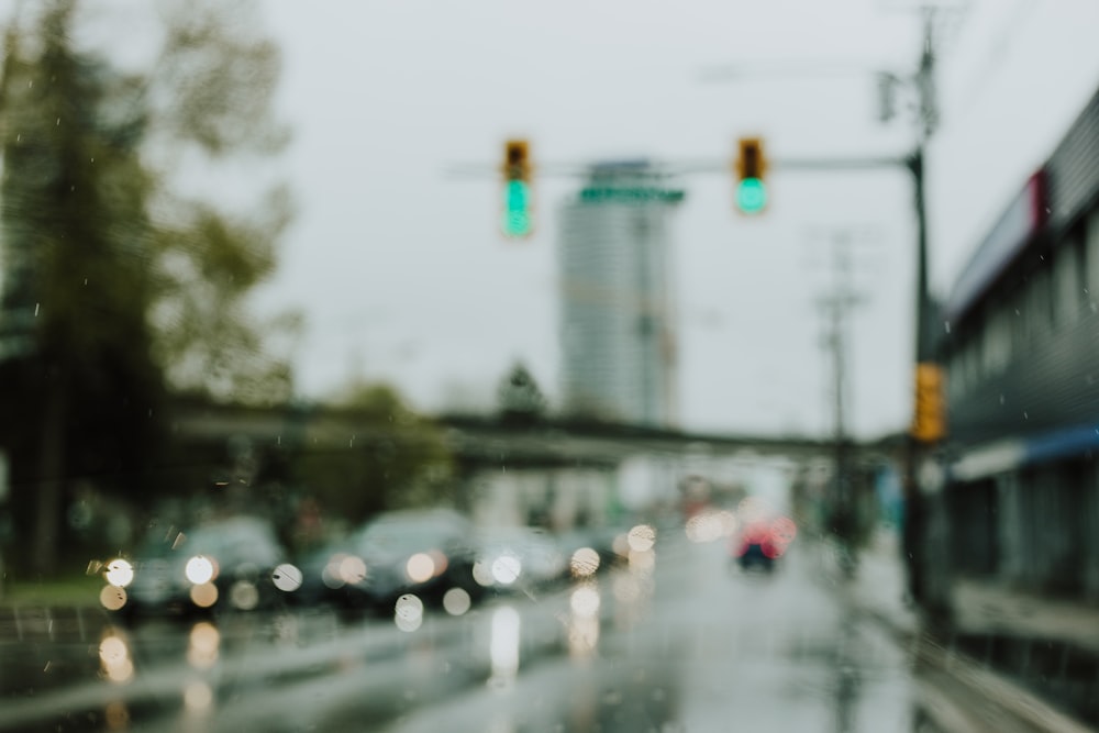 bokeh blurry photography of vehicles passing by road