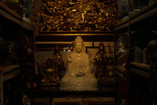 A serene meditation space with soft candlelight and Indian deity statues.