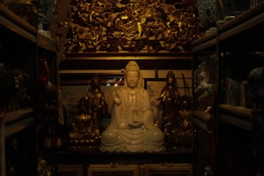 A serene meditation corner featuring a brass deity statue surrounded by candles.
