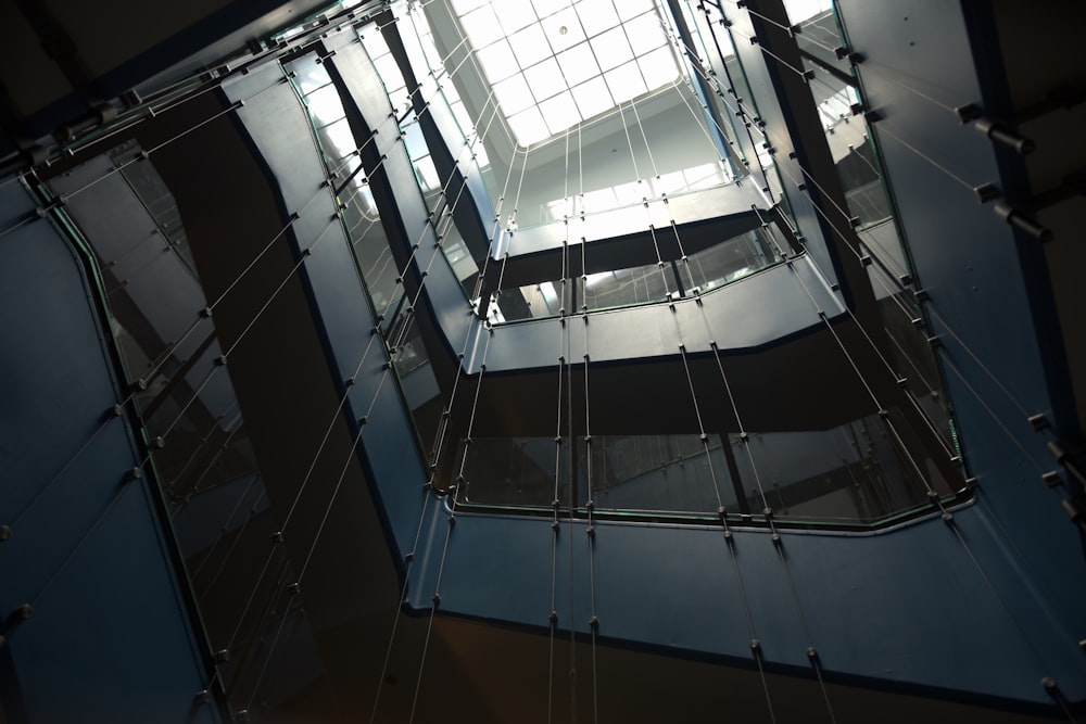 low-angle photography of multi-storey building with glass ceiling