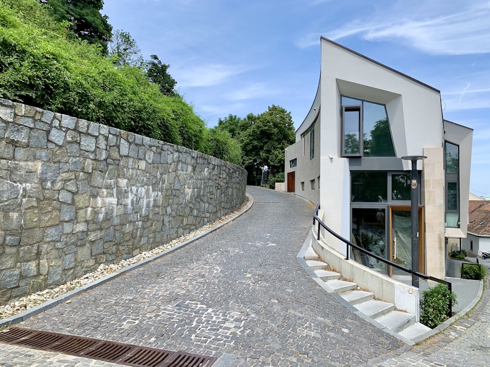 pathway near white concrete building during datime