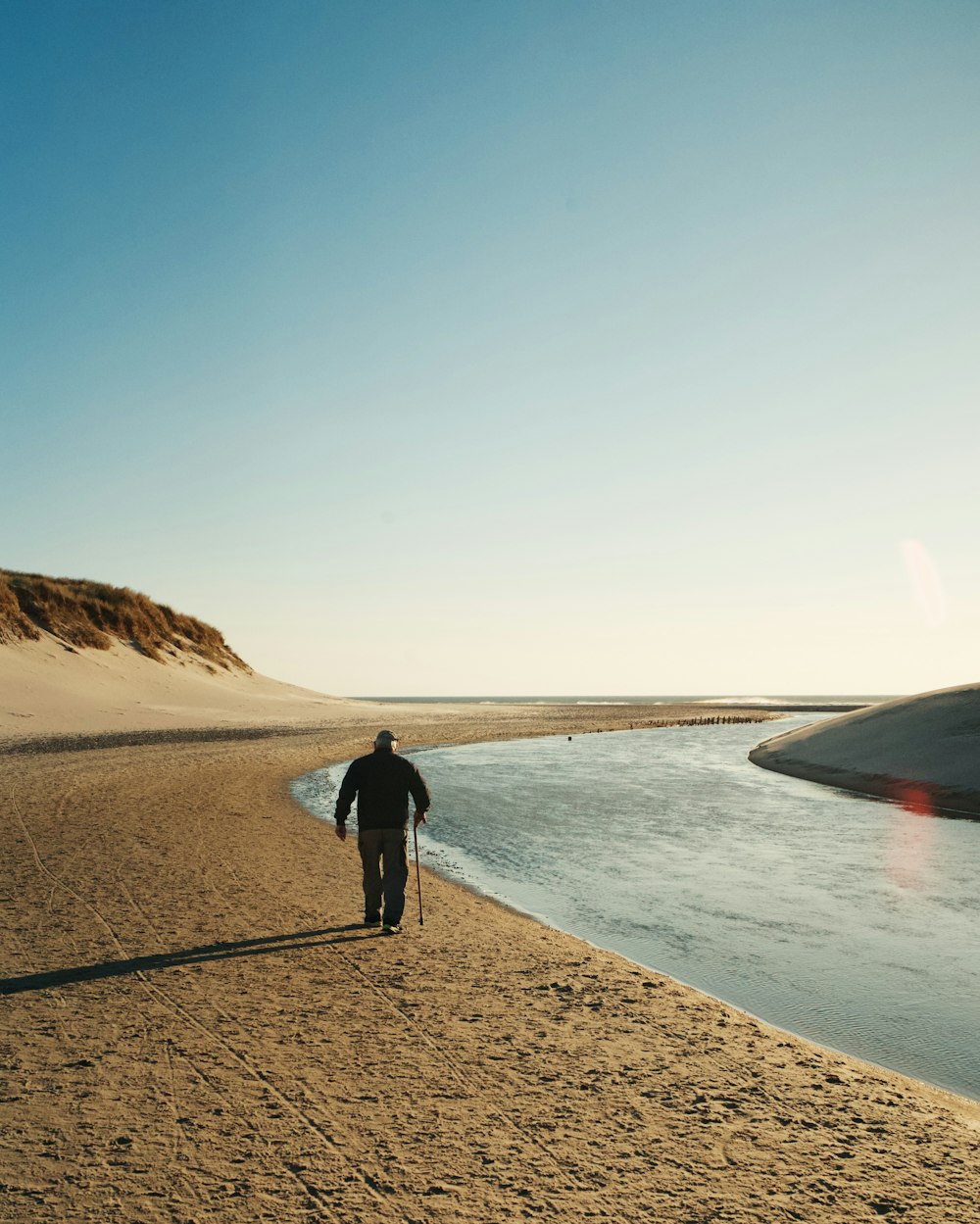 man walking on seashore