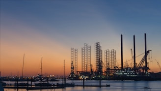 silhouette of building construction beside the river