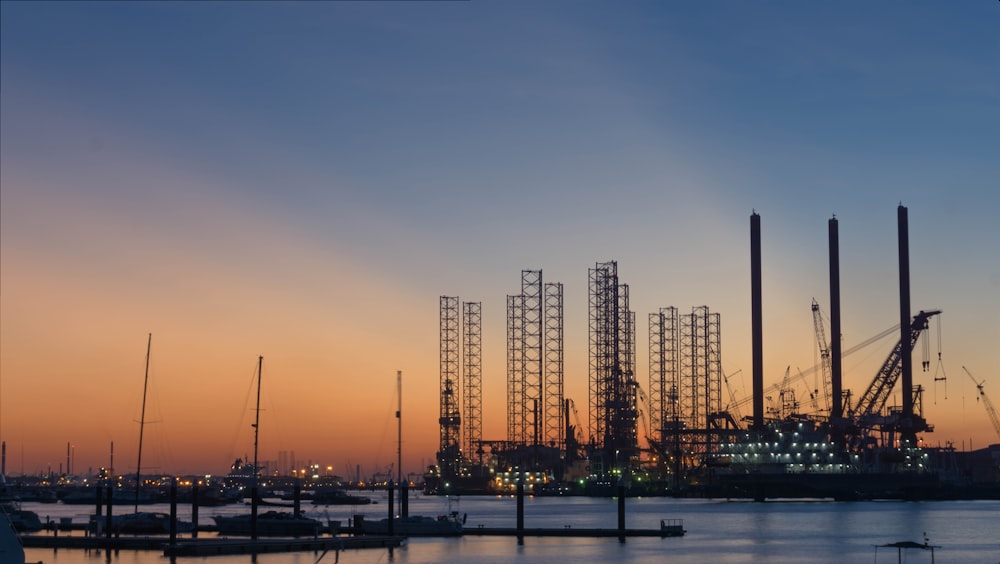 silhouette of building construction beside the river