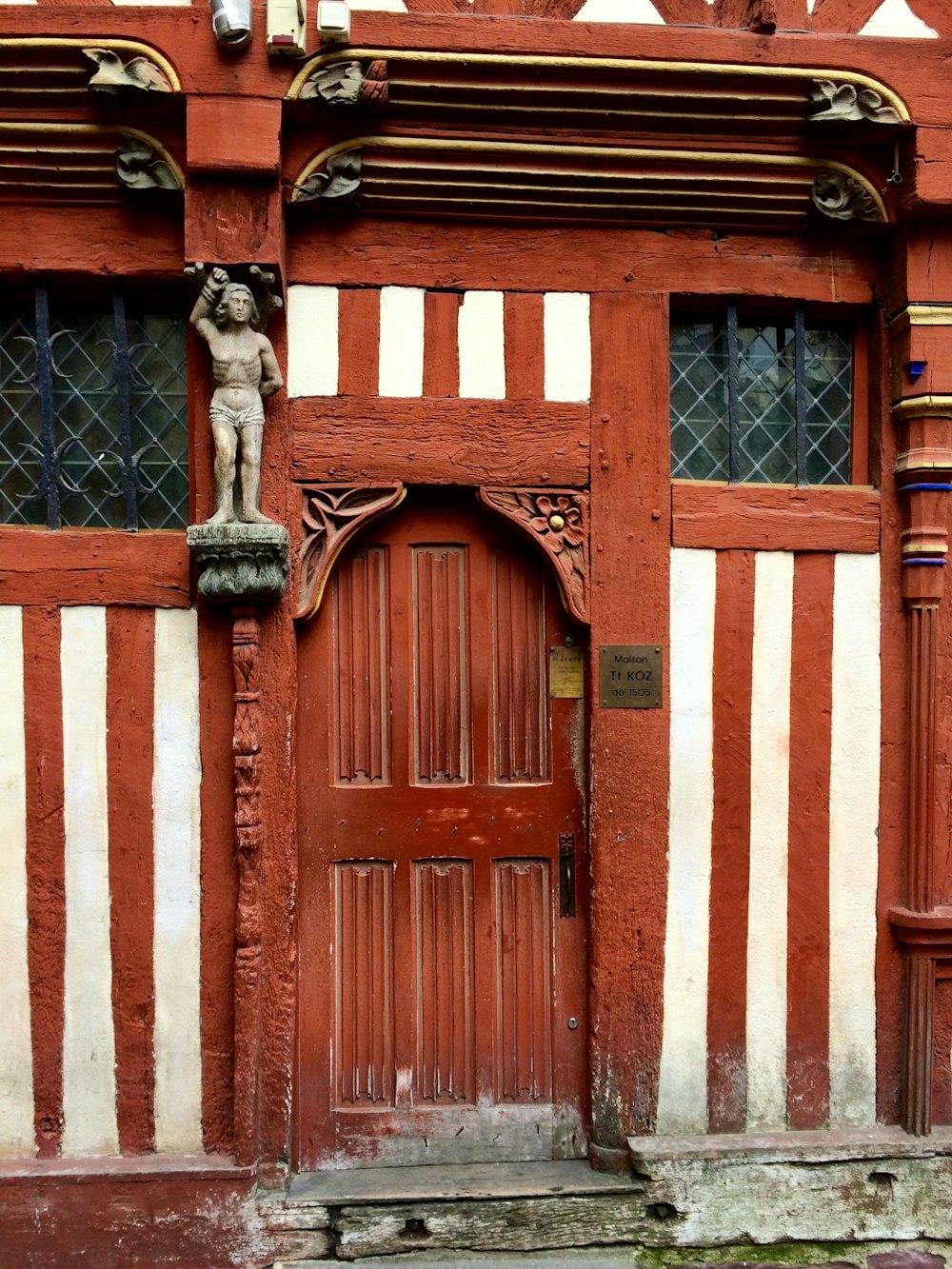 Edificio blanco y marrón con puerta de arco